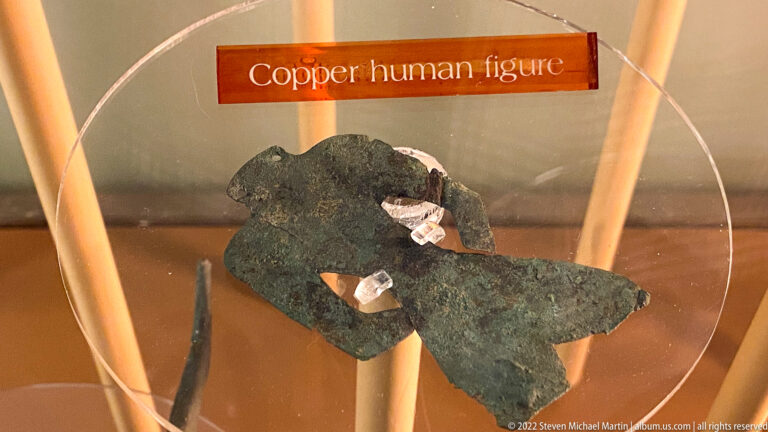 A small green-brown copper figure is mounted beneath a label reading Copper human figure.