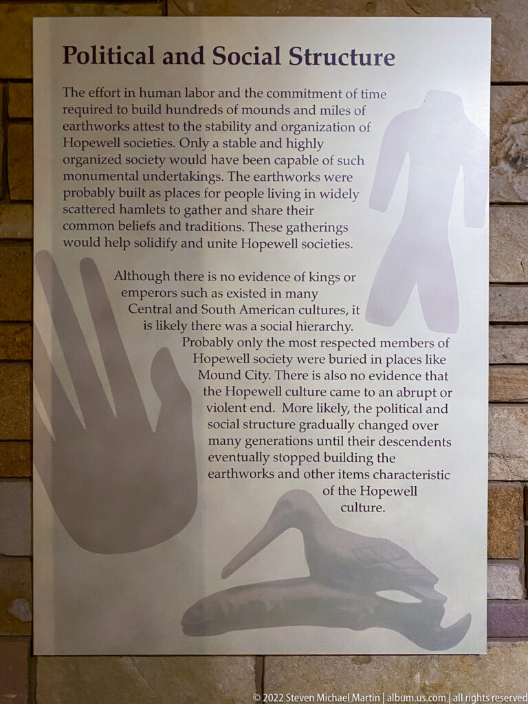 A Political and Social Structure panel overlays text on large hand and bird-like silhouettes.