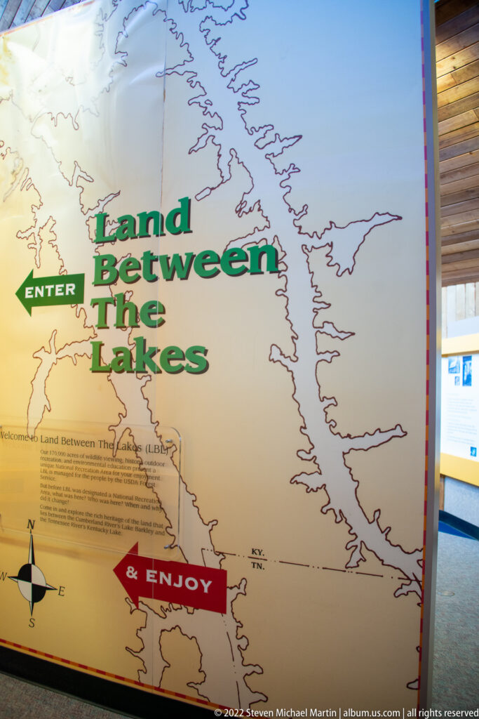 A wall map labeled Land Between the Lakes includes an Enter arrow and red Enjoy marker.