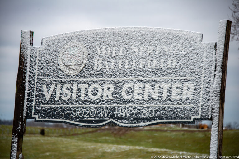 A frosted sign reads Visitor Center, with a smaller address line beneath.