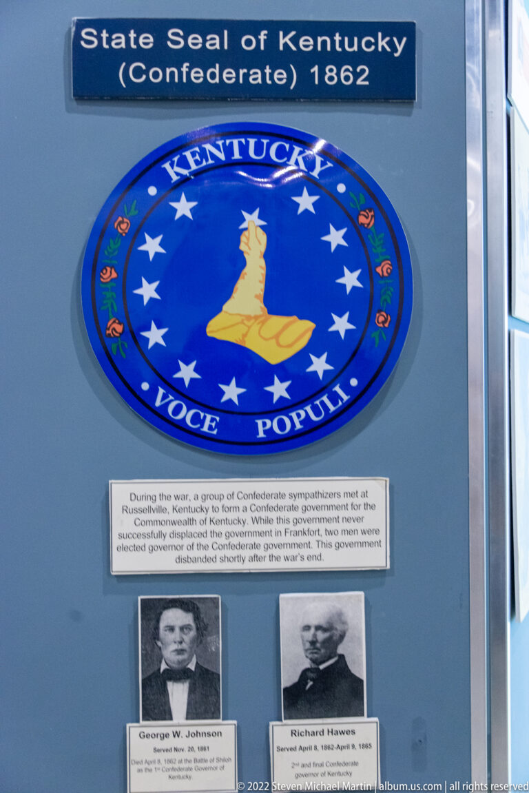 Blue Confederate Kentucky seal reading “Vox Populi,” with stars around a central state outline.