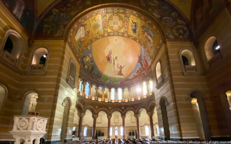A figural scene fills the apse above a band of narrow windows, with the sanctuary visible below.