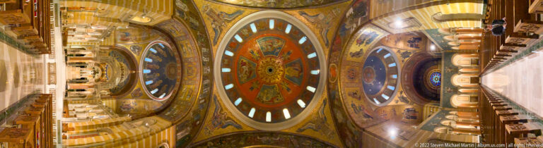 Circular mosaic panels and arched windows align along the cathedral’s decorated vault.