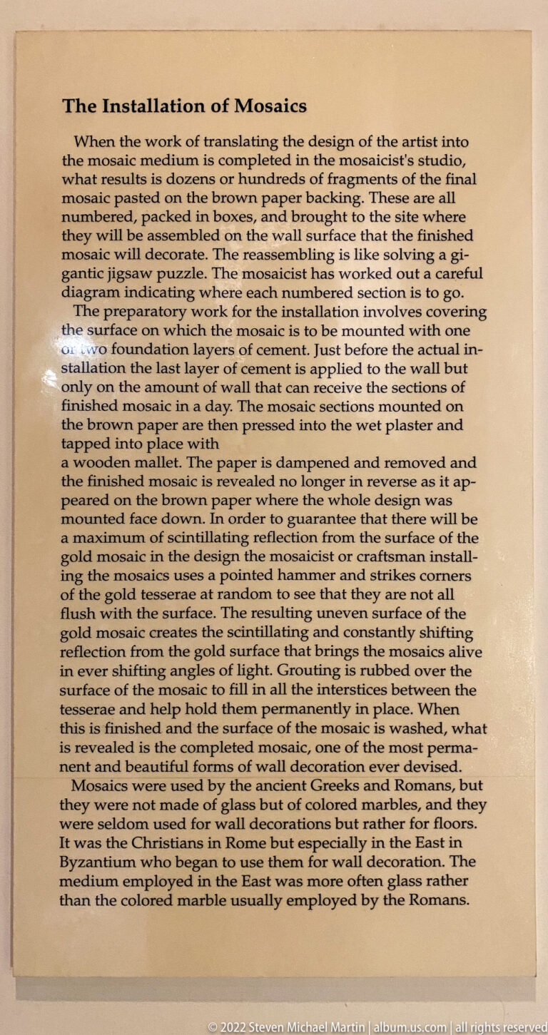 A printed panel explains the installation of mosaic sections on a wall.