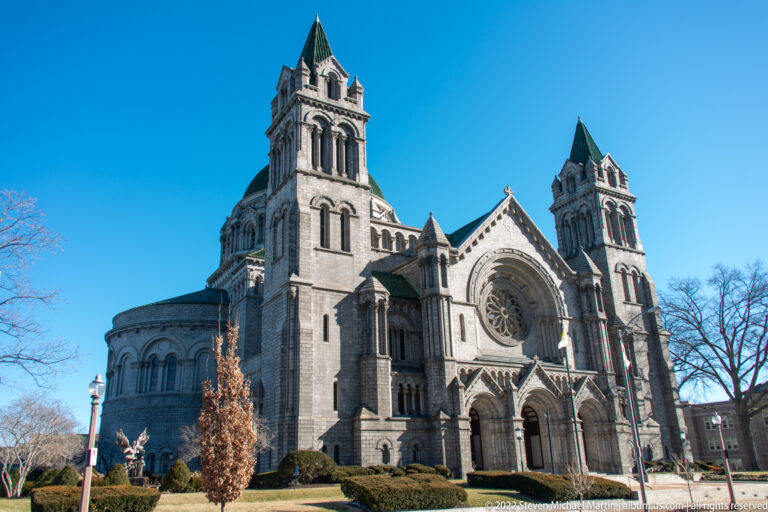 Two green-roofed towers flank the cathedral’s central rose window and three arched entrance portals.