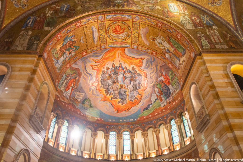 A cathedral apse scene shows a central group surrounded by flames and worshippers above a row of windows.