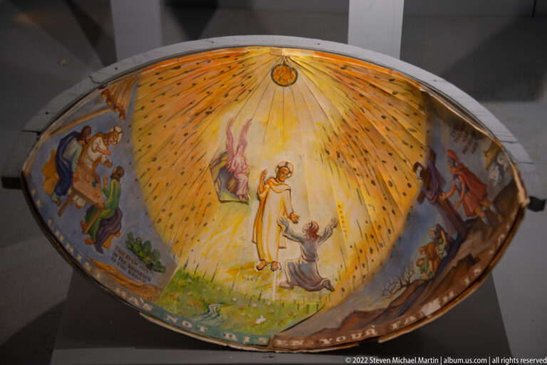 An oval ceiling painting shows a radiant central figure above a kneeling person, with groups of robed figures on either side.
