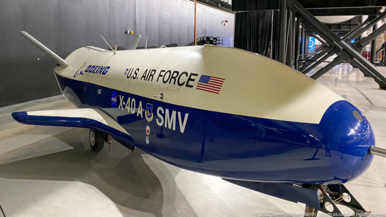 The white-and-blue X-40A demonstrator bears U.S. Air Force, Boeing, NASA, and SMV markings.
