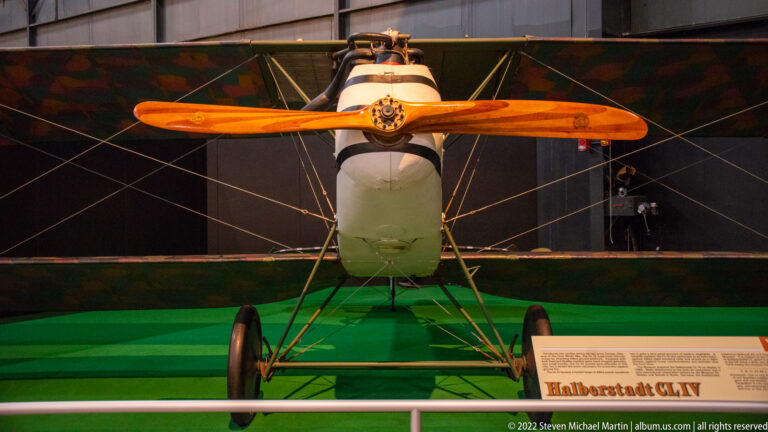 A Halberstadt CL.IV faces forward with a wooden propeller, pale fuselage, and broad wings.