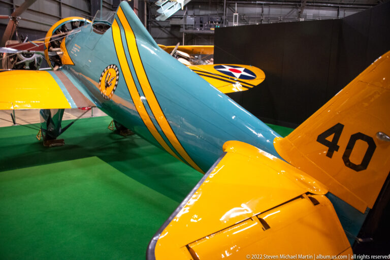 A yellow tail marked 40 rises above a turquoise fuselage, with another aircraft’s star-marked wing behind it.
