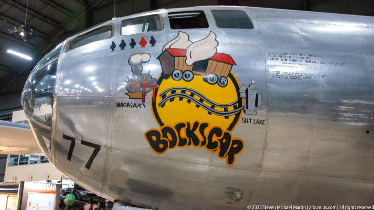 The silver Bockscar nose bears a cartoon train emblem and the painted names Nagasaki and Salt Lake.