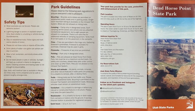 An open visitor guide shows safety information beside a vertical canyon photograph labeled Dead Horse Point State Park.