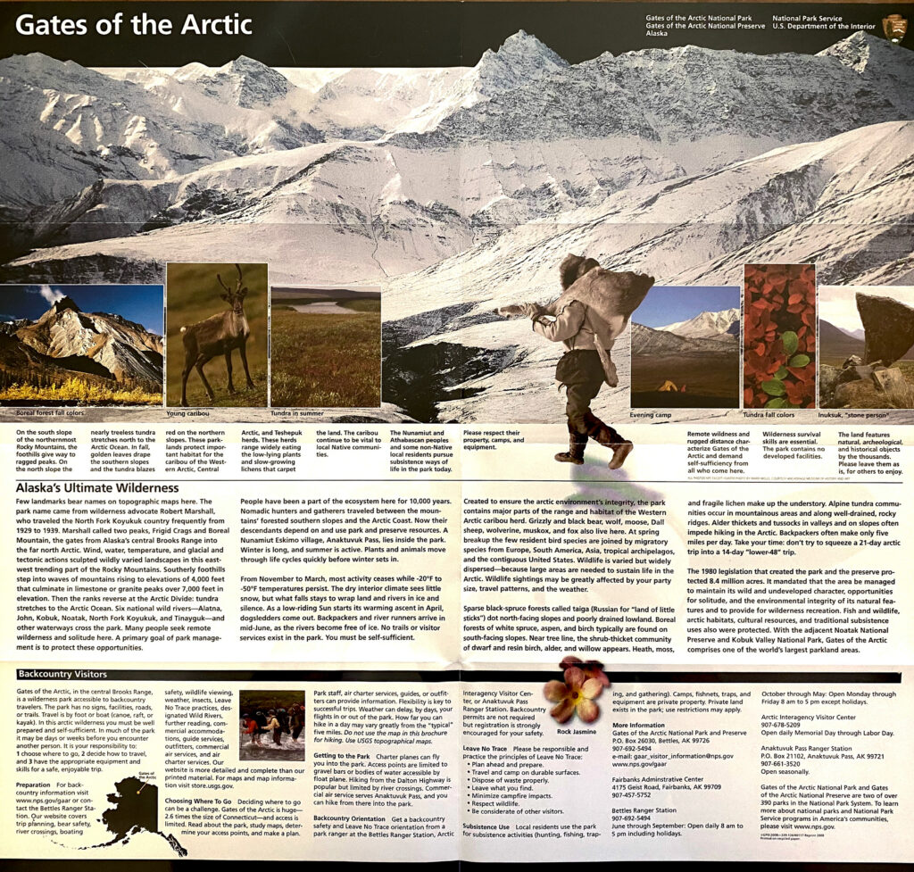 A printed park information page shows a snowy mountain and hiker above inset nature photographs and columns of small text.