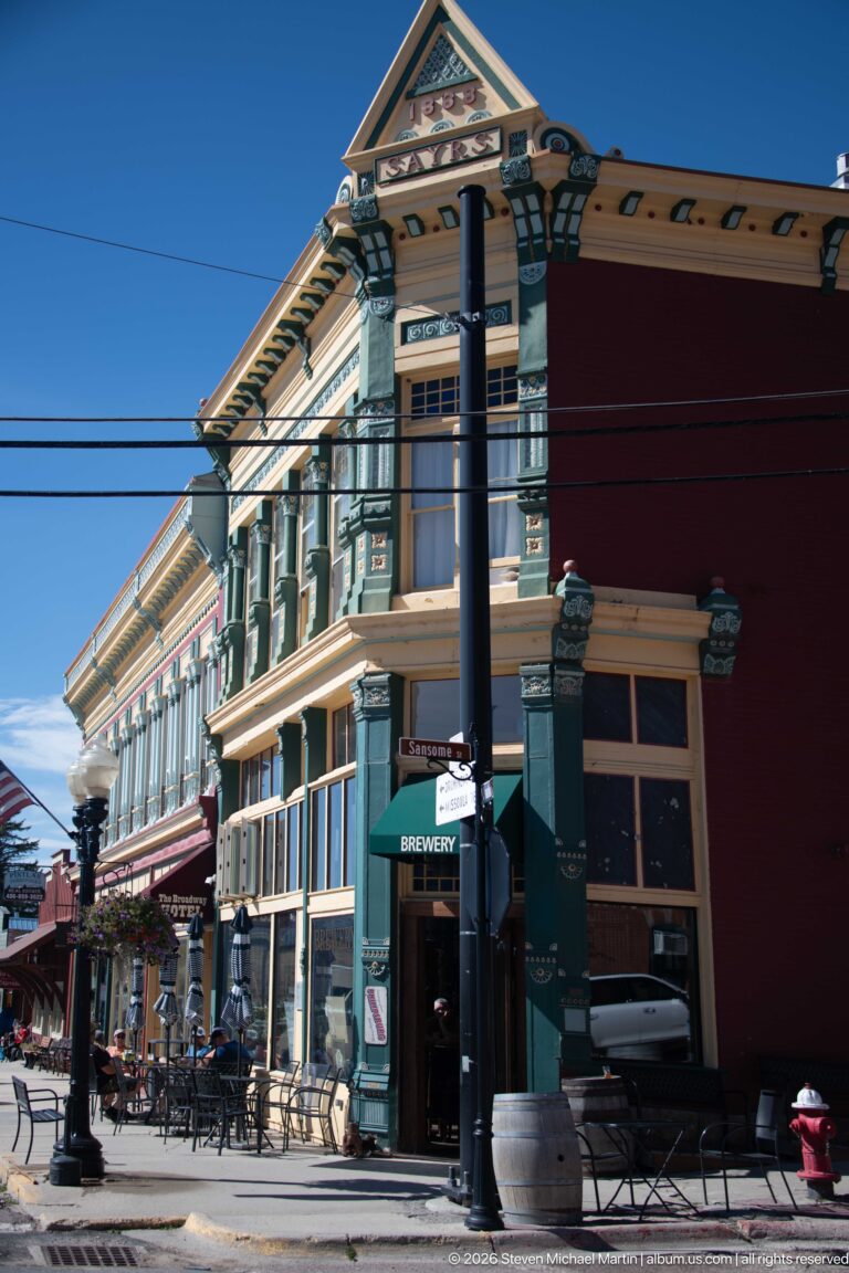 Ornate Walker Commercial Company building housing Philipsburg Brewing Company, with brewery entrance, outdoor tables, and decorated upper façade.