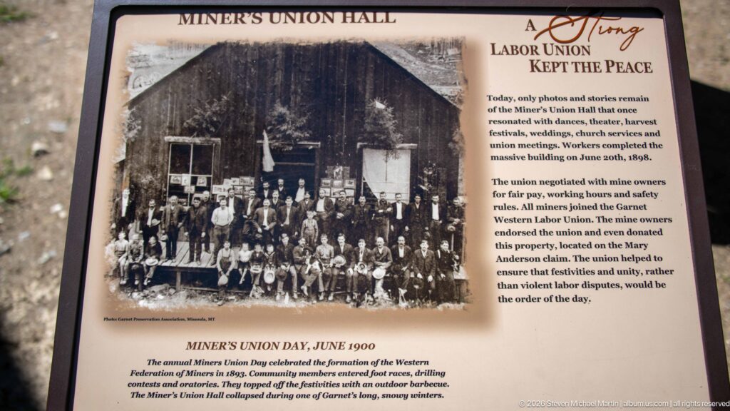 Miner’s Union Hall interpretive panel with a June 1900 group photograph and text about Garnet’s labor union and community events.