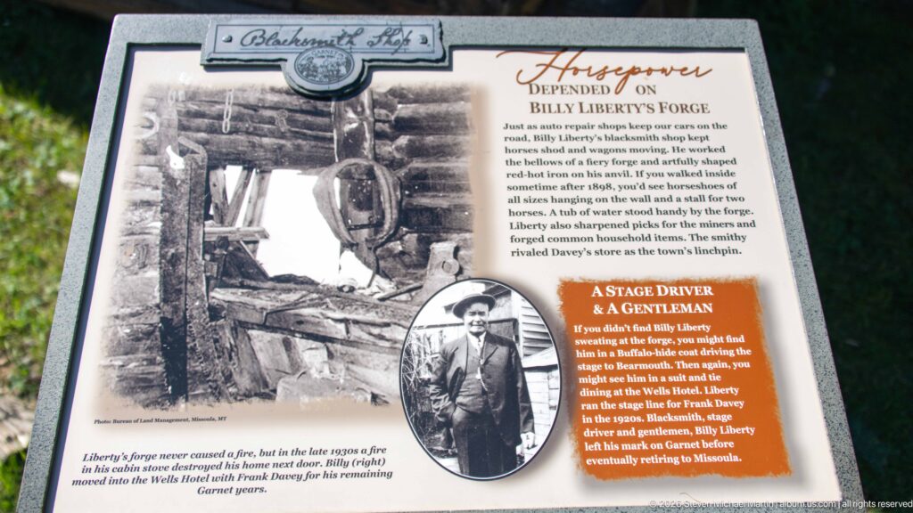 Interpretive panel about Billy Liberty’s forge, with historic blacksmith-shop and portrait photographs and explanatory text.
