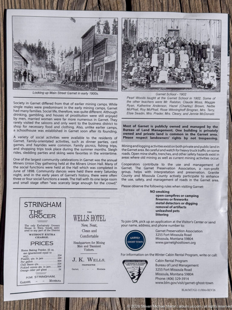 Large Garnet interpretive panel with historic town and group photographs, descriptive text, old advertisements, and visitor information.