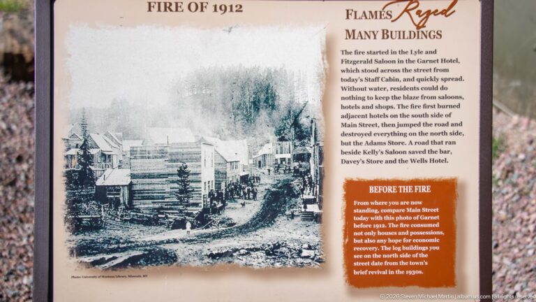 Fire of 1912 interpretive panel with a large historic photograph of Garnet’s Main Street buildings before the blaze.