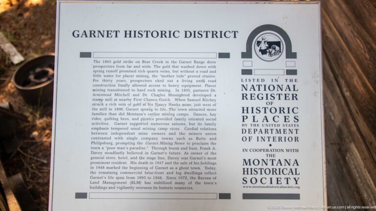 Garnet Historic District plaque with National Register of Historic Places emblem and a long text describing the district’s mining history.