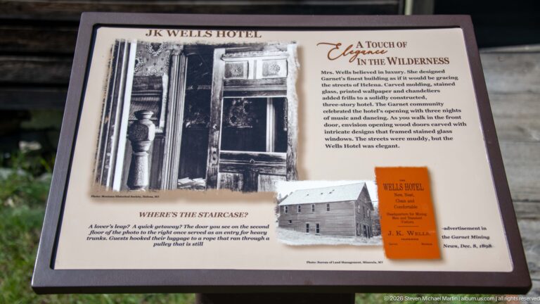 Wells Hotel interpretive panel titled A Touch of Elegance in the Wilderness with historic photographs, an advertisement, and a staircase note.